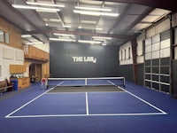 a tennis court in a large building